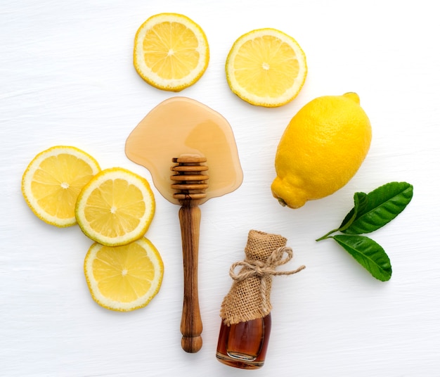 Top view of honey and lemon on white background