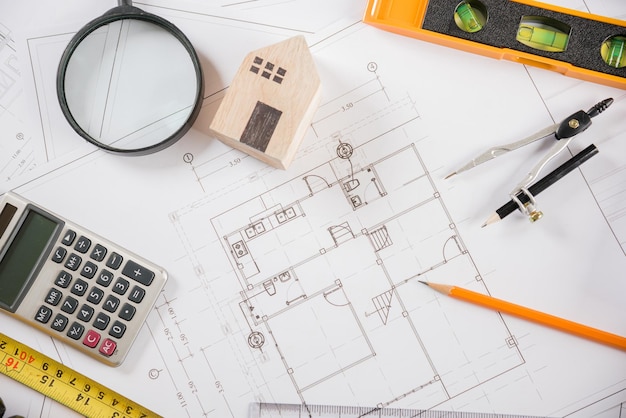 Top view of house plan blueprint paper with repair tools on table desk at architecture office