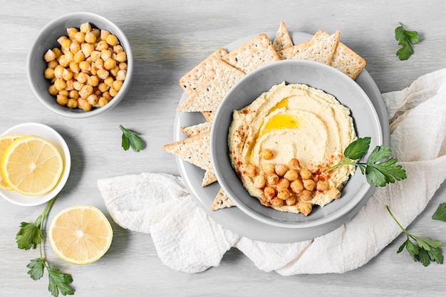 Top view of hummus with chickpeas and lemon