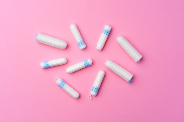 Top view of hygienic tampons on a pink