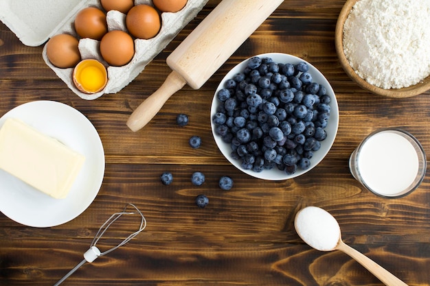 Top view of ingredients for making blueberry pie or cake on the wooden background Copy space Closeup