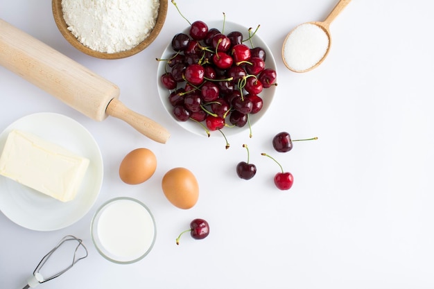 Top view of ingredients for making cherry pie or cake on the white background Copy space