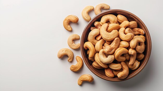 Top view of kaju or cashew nut in a bowl with a big space for text or product in a studio white backdrop Generative AI