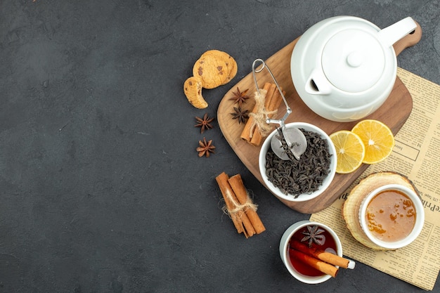 Top view kettle with tea with lemon and honey on dark background egg breakfast meal color table food morning coffee