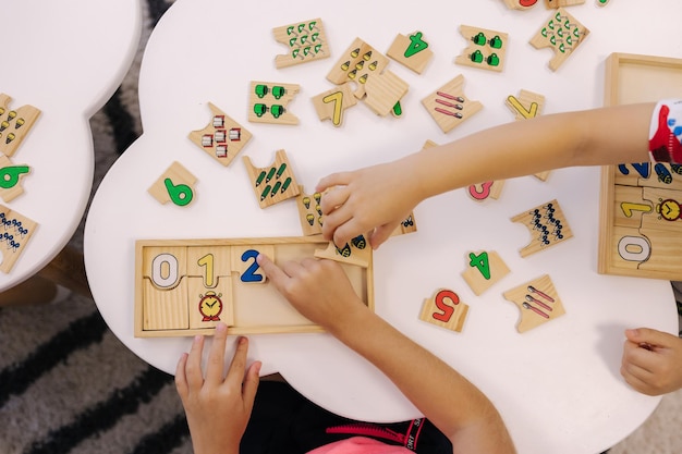 Top view of kids put together educational puzzles