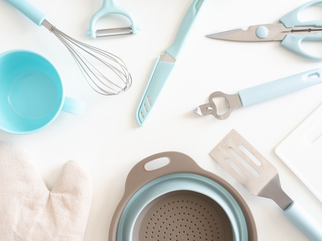 top view of kitchen room concept with kitchenware on white table background.