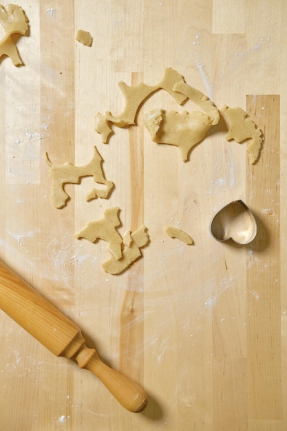 Top view of kitchen table with rests and cuts of dough