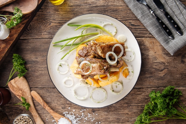 Top view on lamb ribs with potatoes and onion