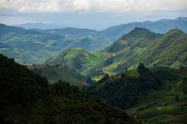 Top view Landscape of Morning Mist with Mountain Layer at north of Thailand mountain ridge and clouds in rural jungle bush forest