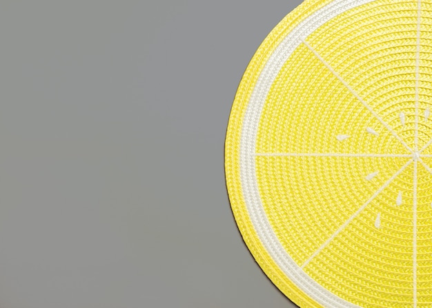 Top view of a lemon placemat on gray with copyspace