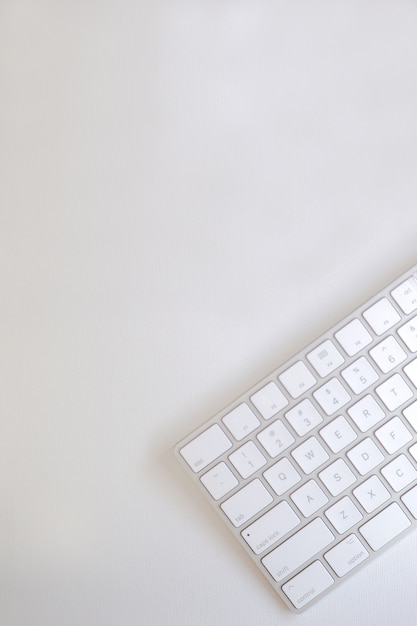 Top view of light bronze keyboard on white canvas.