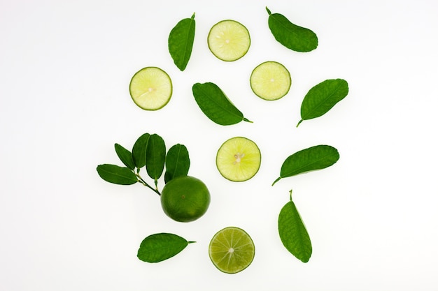 Top view of lime slices fruits and leaves isolated on white