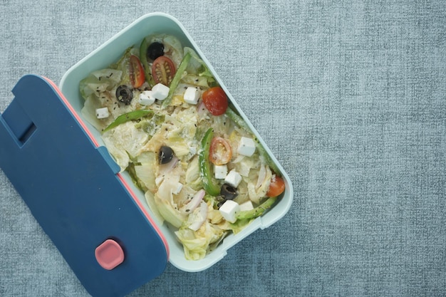 Top view of a lunch box on color background