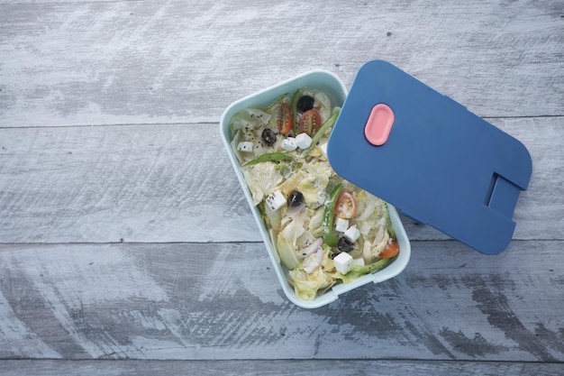 Top view of a lunch box on color background