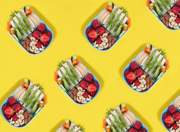 Top view of lunch box on the yellow background Pattern Flat lay