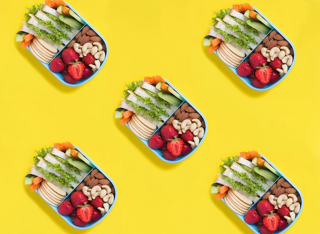 Top view of lunch box on the yellow background Pattern Flat lay