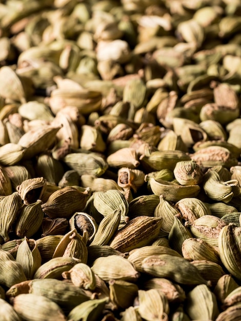 Top view macro closeup on plenty of green cardamom spice