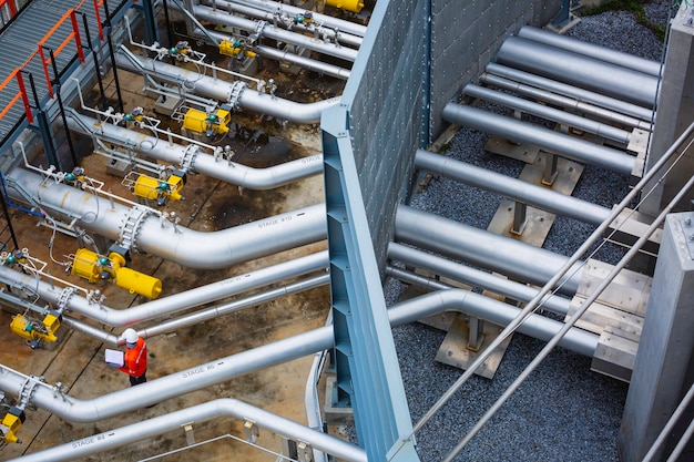 Photo top view male worker inspection at the valve of visual check record pipeline oil and gas industry