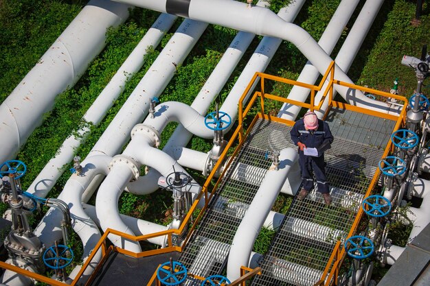 Top view male worker inspection at valve of visual check record pipeline oil and gas industry