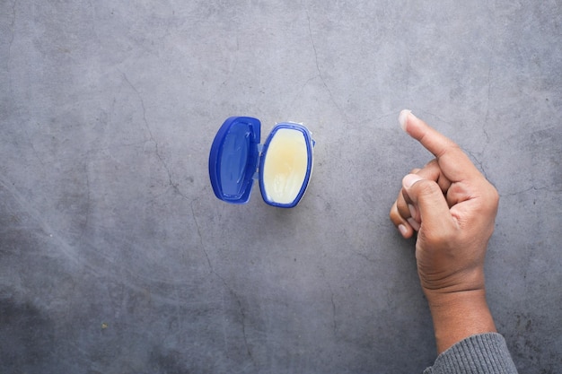 Top view of man hand using petroleum jelly