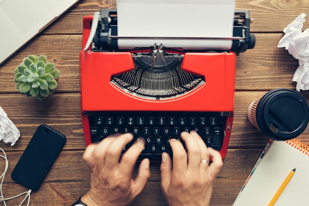 Top view of man using typewriter