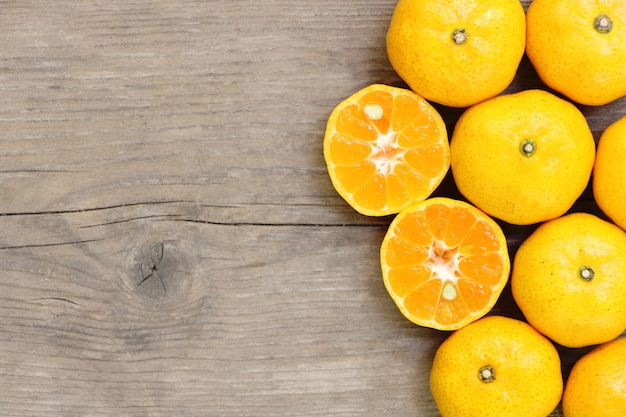 Top view of many orange on wooden table 