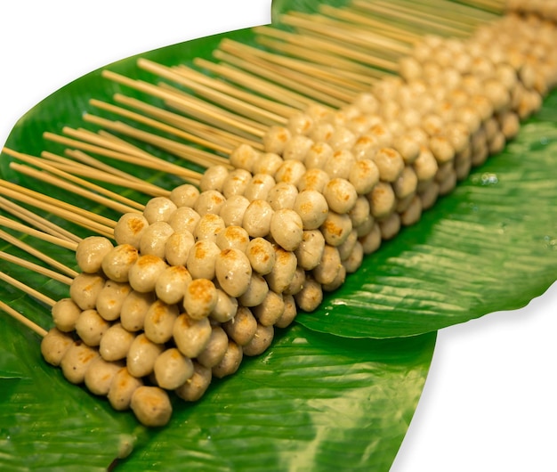 Top view of meatballs grilled skewers placed on banana leaves focus selective