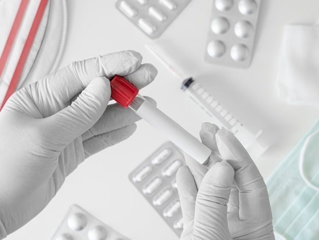 top view of Medical Concept with syringe, Medical Mask, medicine and test tube on white table background