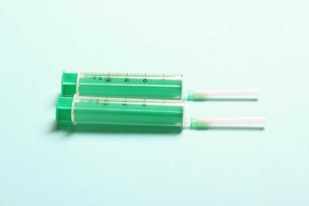 Top view of medical syringes on colorful background with copy space Injection equipment concept