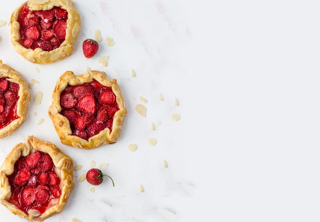 Top view of the mini biscuits with strawberries Small pies on a white background Space for text