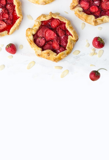 Top view of the mini biscuits with strawberries Small pies on a white background Space for text