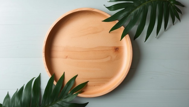 Top view minimal round wooden tray plate on wood plank table counter green tropical fern plant