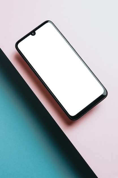 Top view of mobile phone screen blank template on pink and blue background with copy space, minimal design, shapes, colorful background, young style , transgender flag,