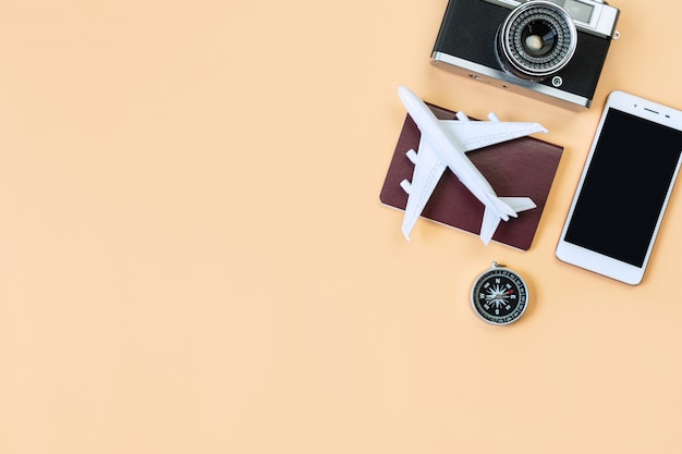 Top view of model plane, passport, compass and mobile phone, travel concept. Flat lay , copy space