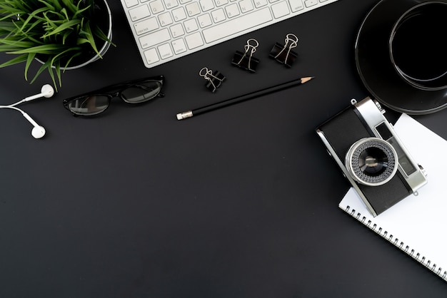 Top view modern black desk work table with computer laptop and stationary in home office