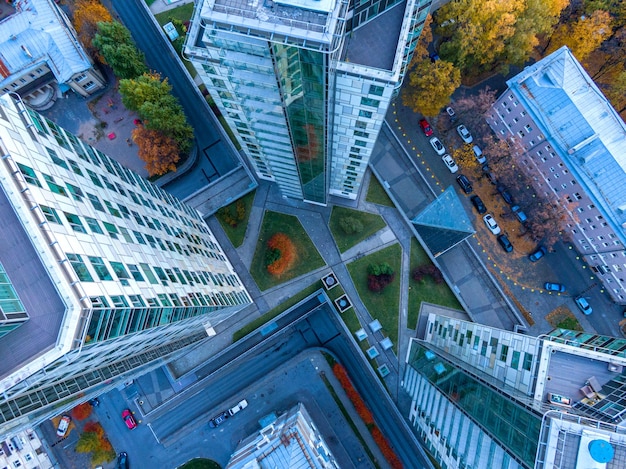 Top view on modern city building complex with autumn green