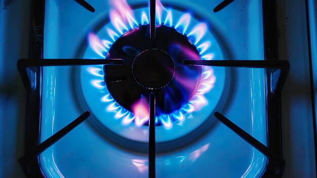 Photo top view of modern gas hob displaying vibrant flames