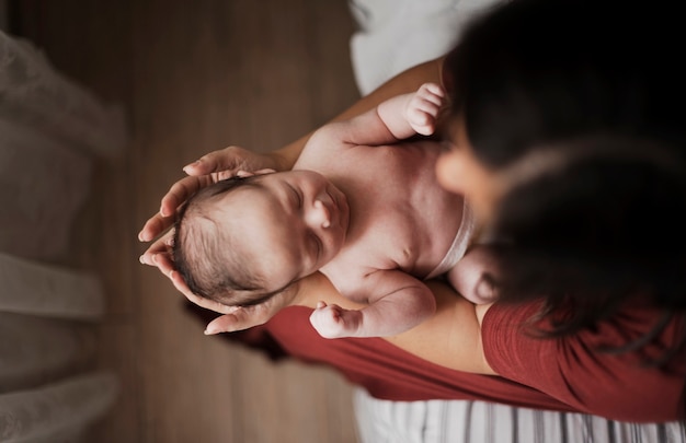 Top view mother holding little baby