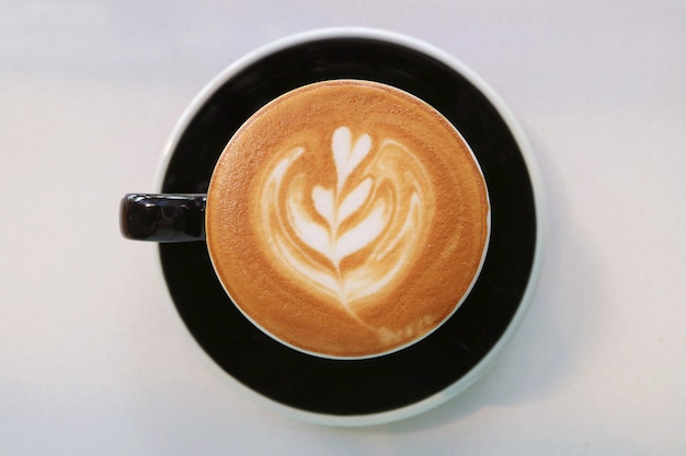 Top view of mouthwatering frothy cappuccino coffee with beautiful latte art