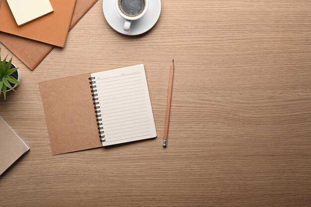 Photo top view notebook coffee cup and sticky note on wooden table