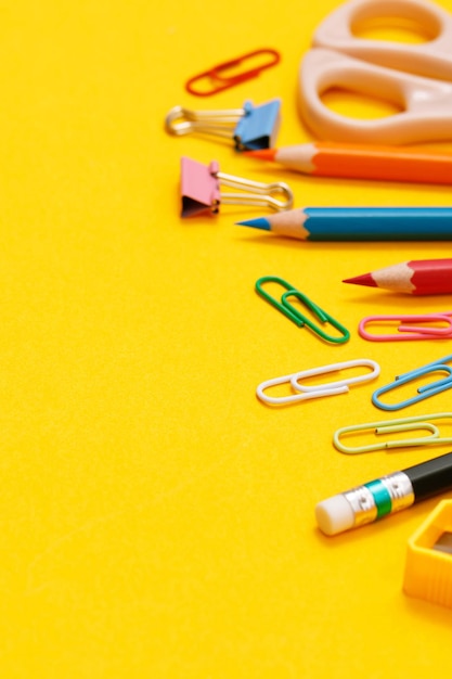 Top view notebooks and accessories studying in the library at school yellow background idea education