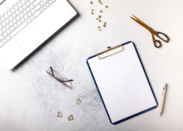 Top view of notepad with laptop and glasses