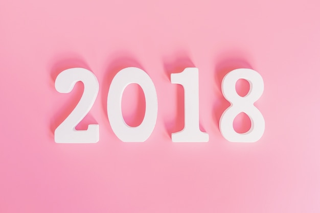 Top view number of 2018 for new year on pink pastel color.