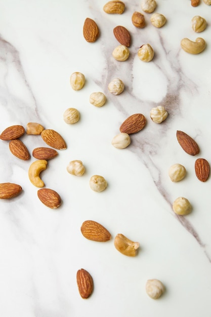 Top view of nuts arrangement concept on marble texture