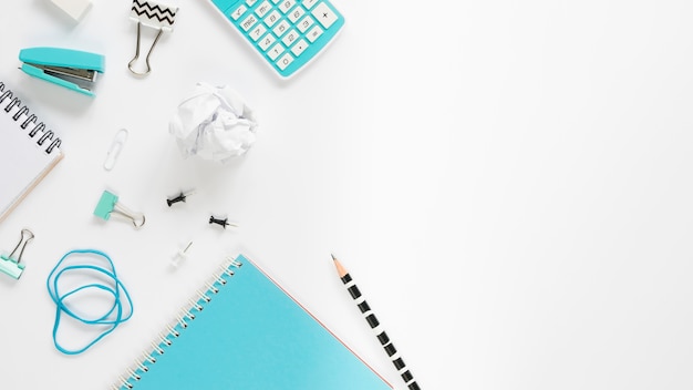 Top view of office stationery with notebooks and copy space