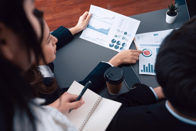 Top view office workers analyze financial report paper in harmony workplace