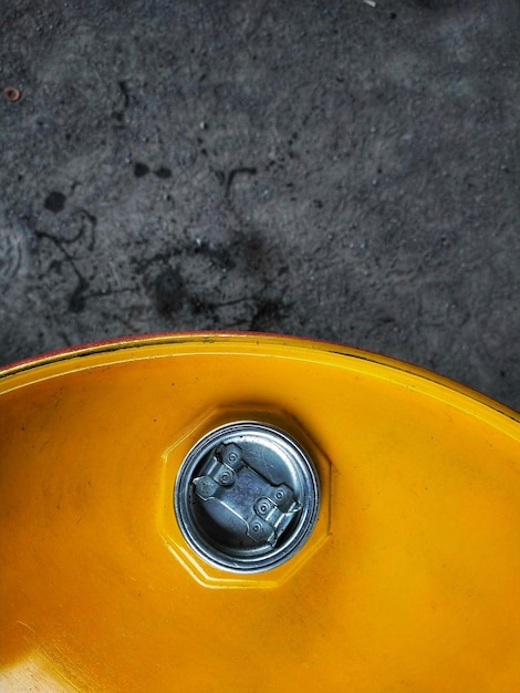 Top view of oil drum cover with a little oil spill on the ground