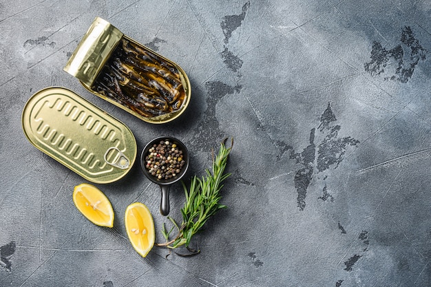 Top view of an opened can on grey textured stone background