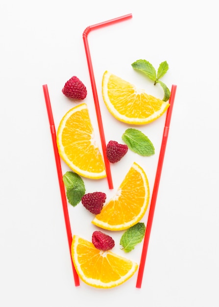 Top view of orange slices in straw glass with mint