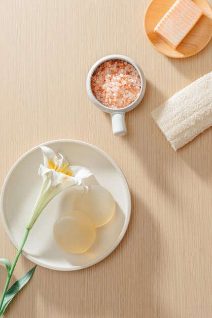 Top view of organic spa skincare products with salt flowers towels and rice soaps